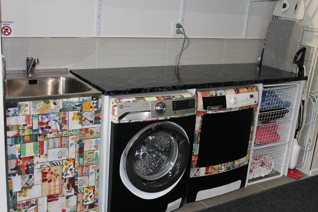 colourful vinyl on laundry with black marble bench top