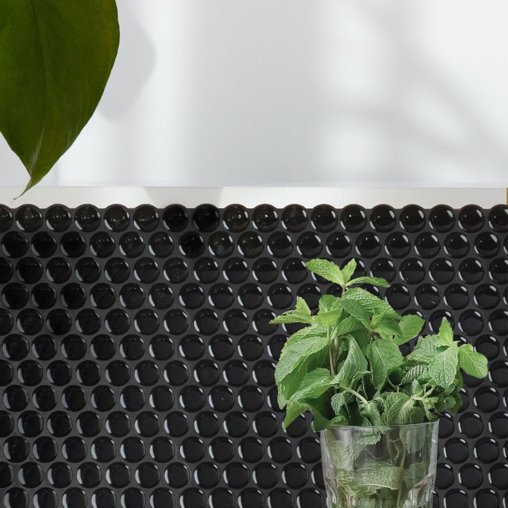 Black penny round self-adhesive 3D tiles as splash back