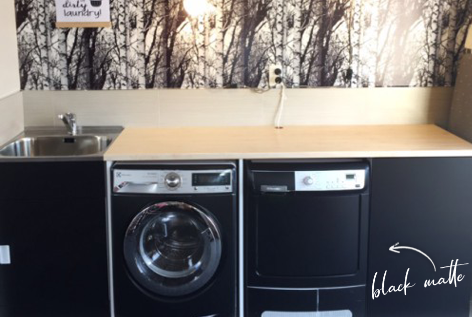 Laundry, dryer and cupboards wrapped in black matte self-adhesive vinyl, birch vinyl benchtop and black and white wood patterned wall vinyl