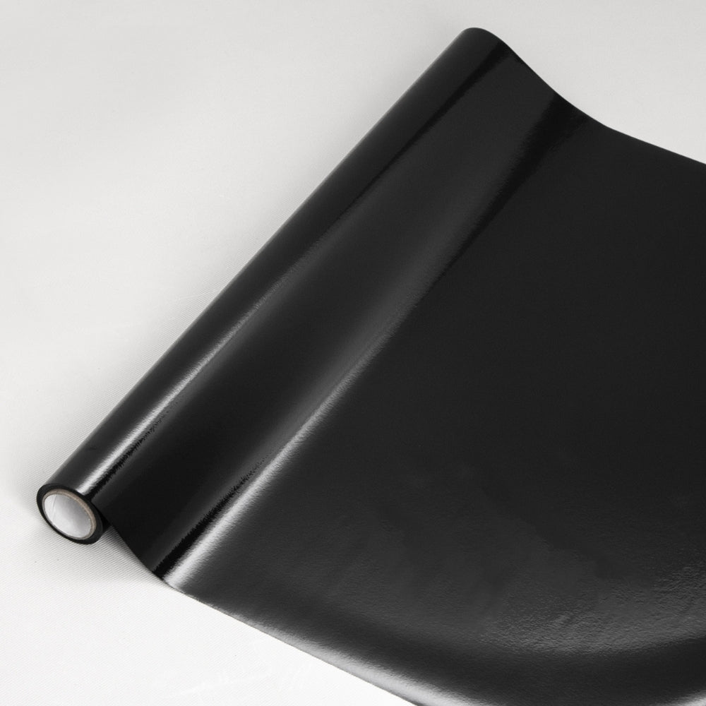 Roll of blackout window film on a white background