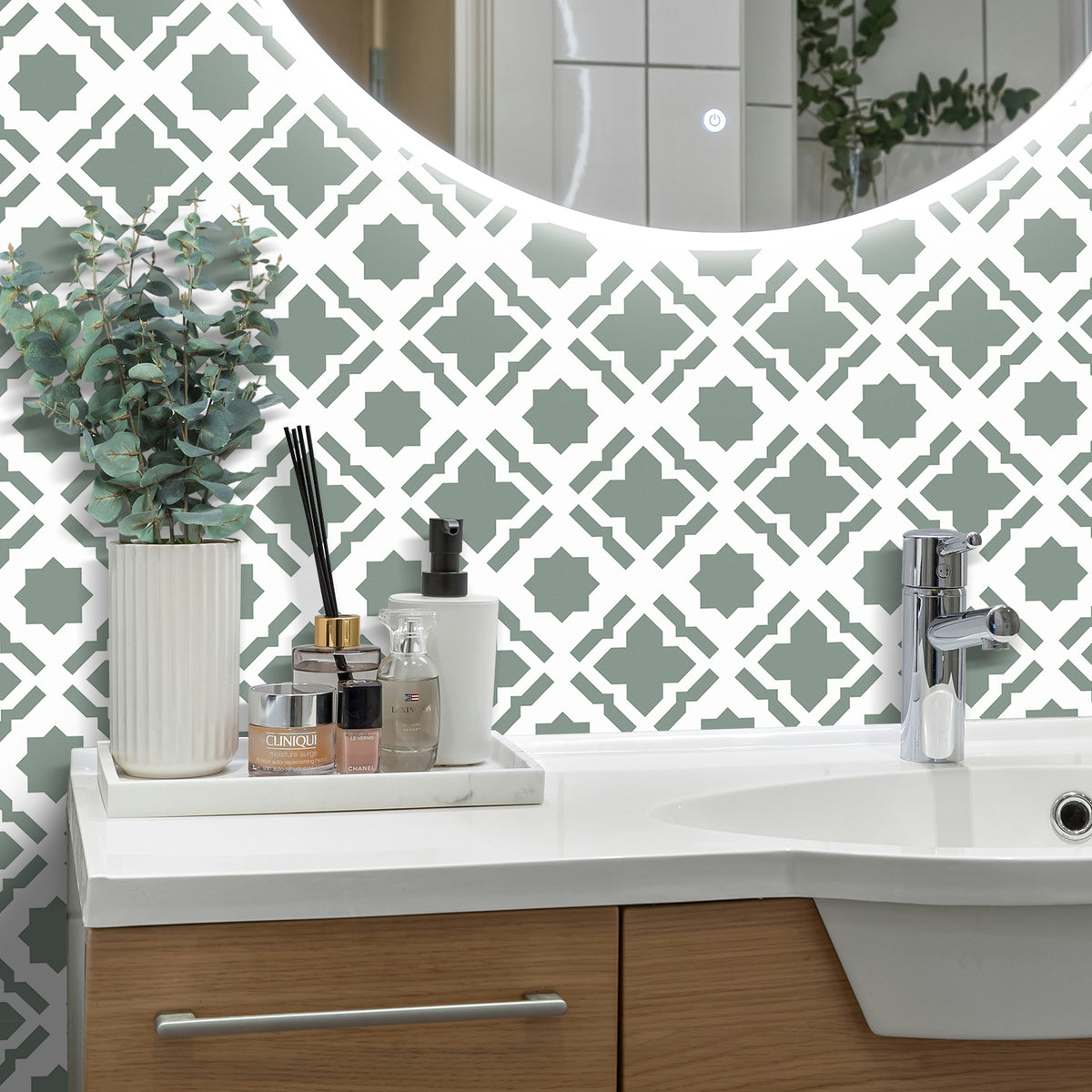 Bathroom vanity with decorative wall tiles and a mirror.