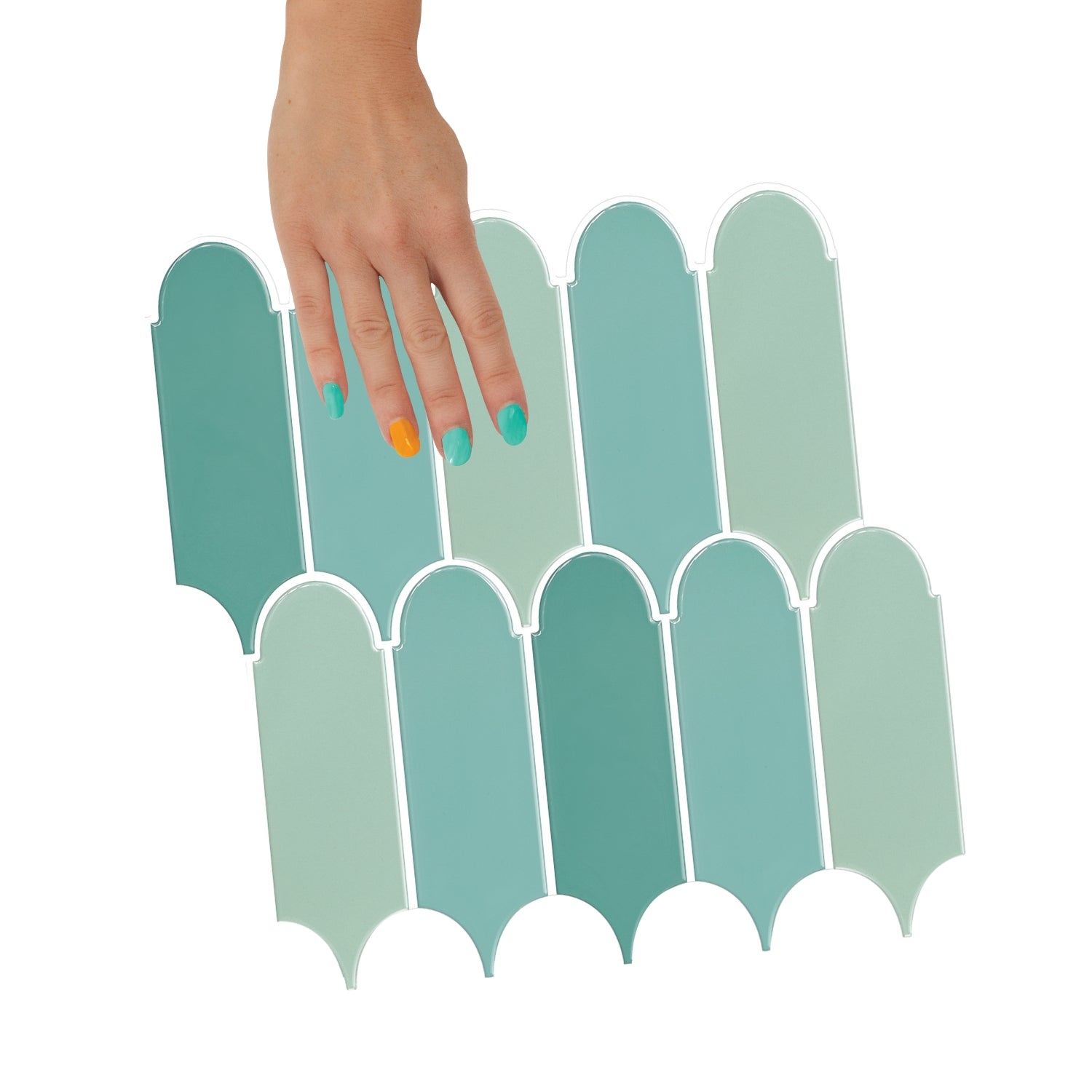 Decorative wall with green geometric pattern and ceramic pitcher on a wooden surface