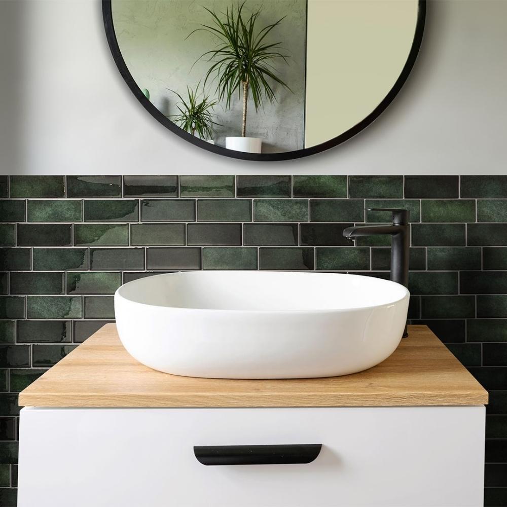 Green self-adhesive 3D subway tile in a bathroom