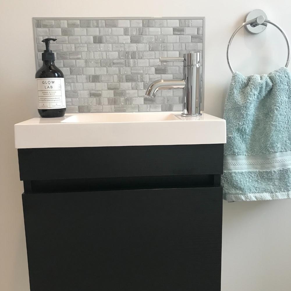 Grey stone mosaic self-adhesive 3D tiles above vanity