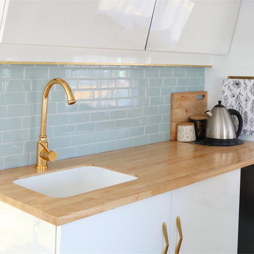 Grey green self-adhesive 3D subway tile in a caravan