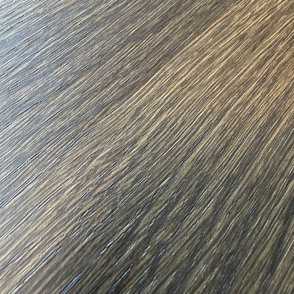 Close-up of Oak flat grain dark adhesive vinyl