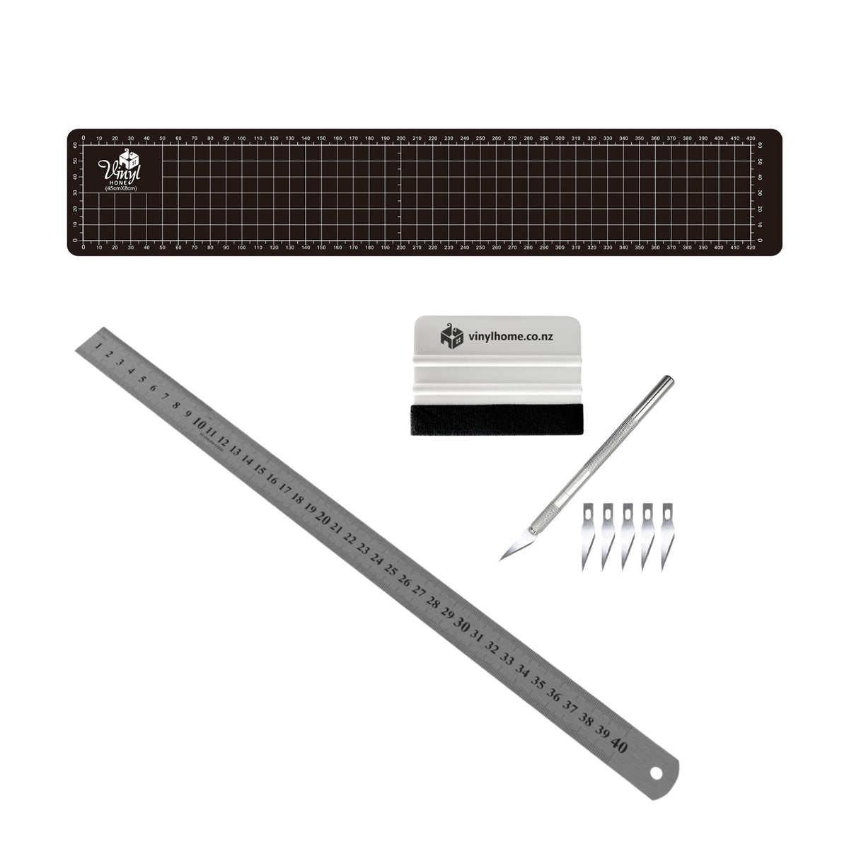 Set of vinyl cutting tools including a ruler, blade, and accessories on a white background.