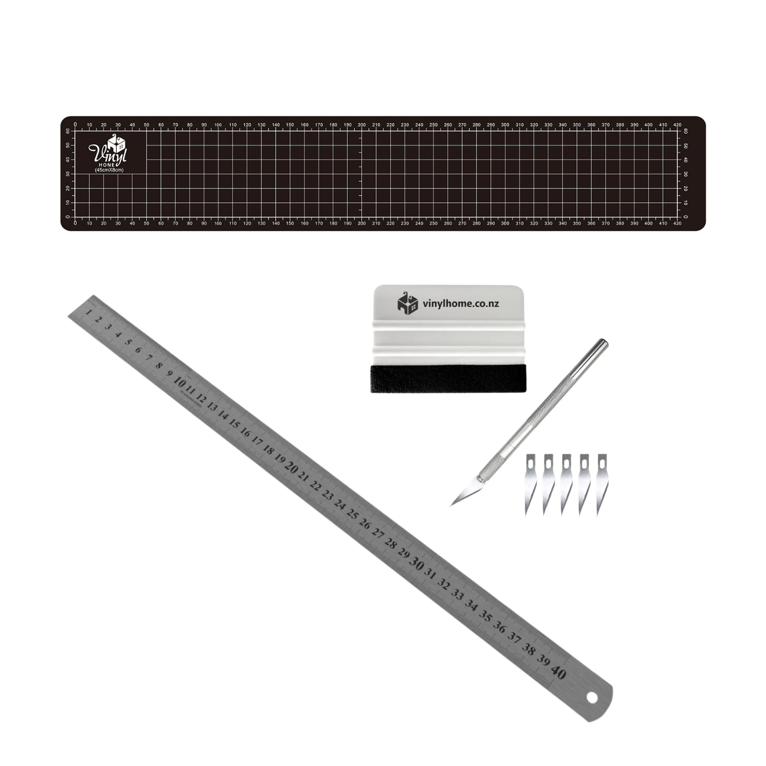 Set of vinyl cutting tools including a ruler, blade, and accessories on a white background.