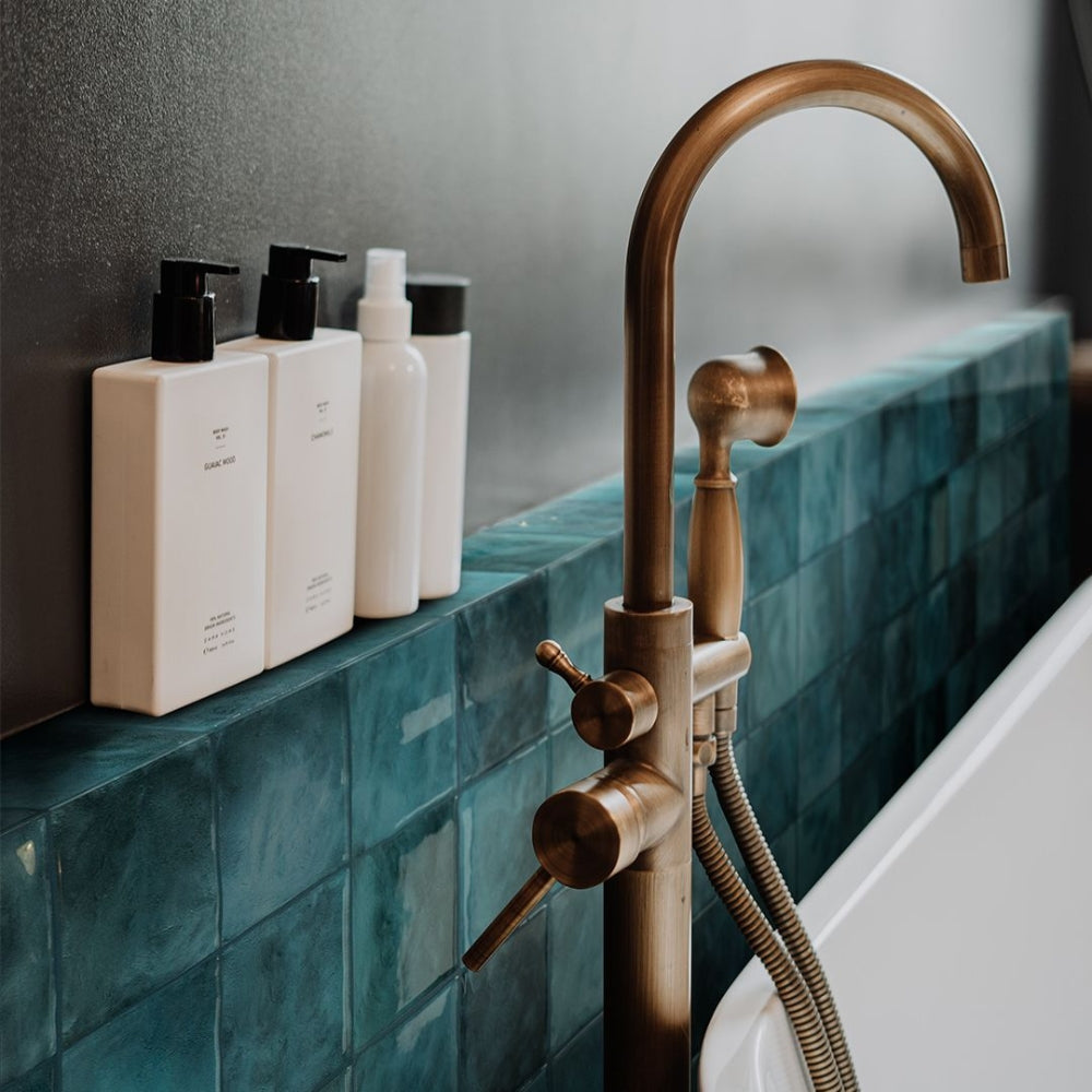 Turquoise square tiles in bathroom that is self-adhesive