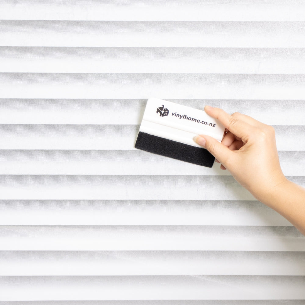 Venetian blind widow film applied with a squeegee