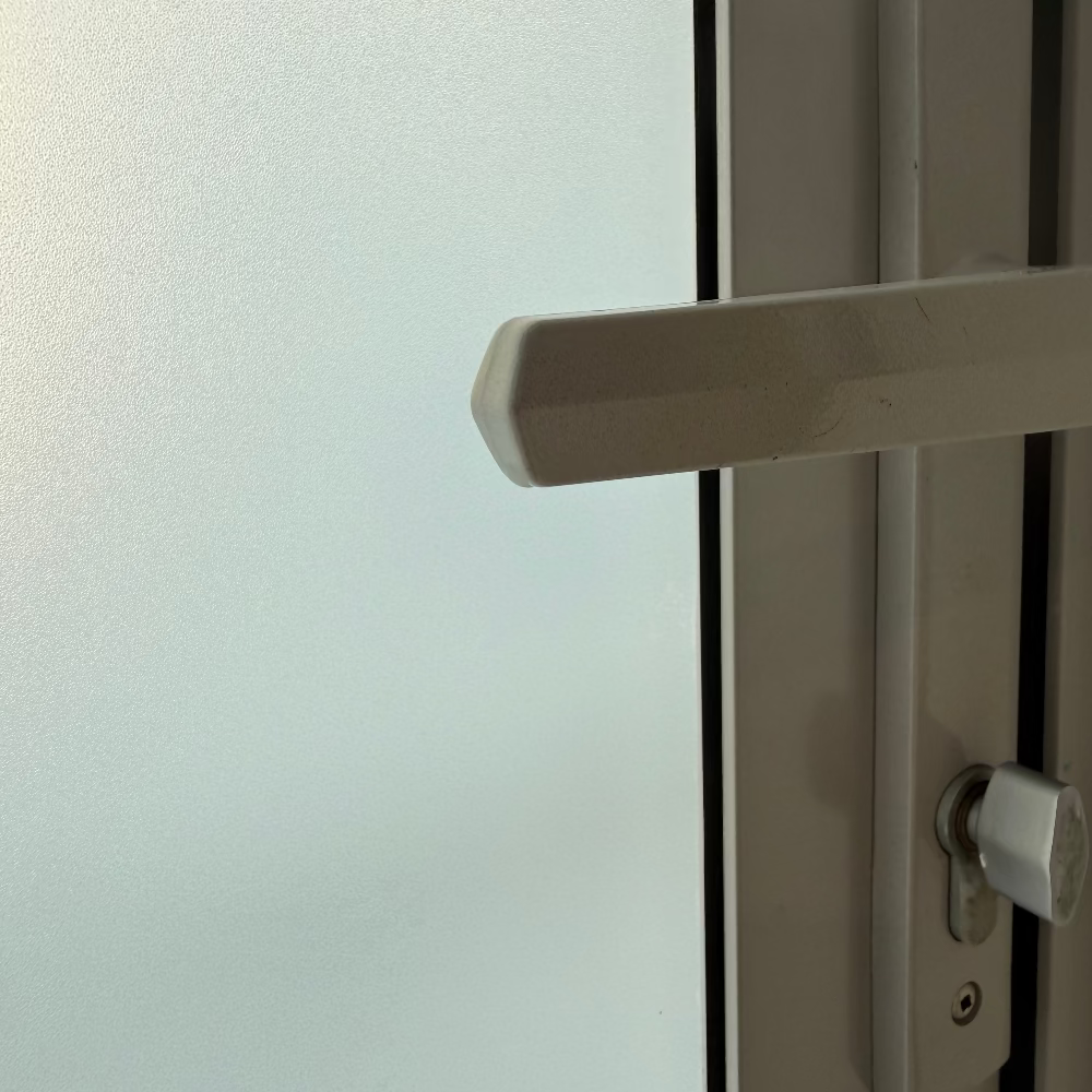 Close-up of a door handle on a glass door