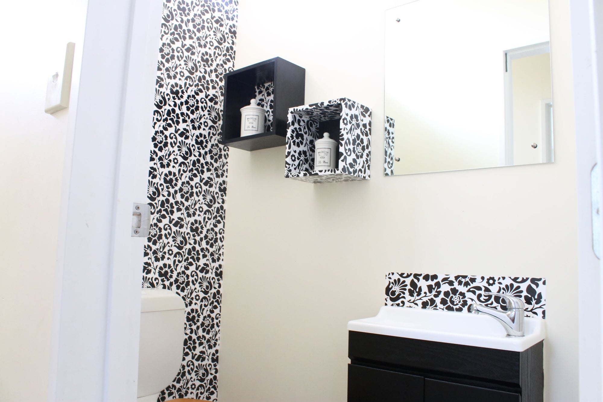 black and white decorated toilet seen from doorway