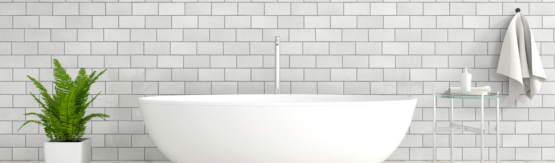white on top handbasin in front of grey subway tiles and green plant to the left and white towel to the right