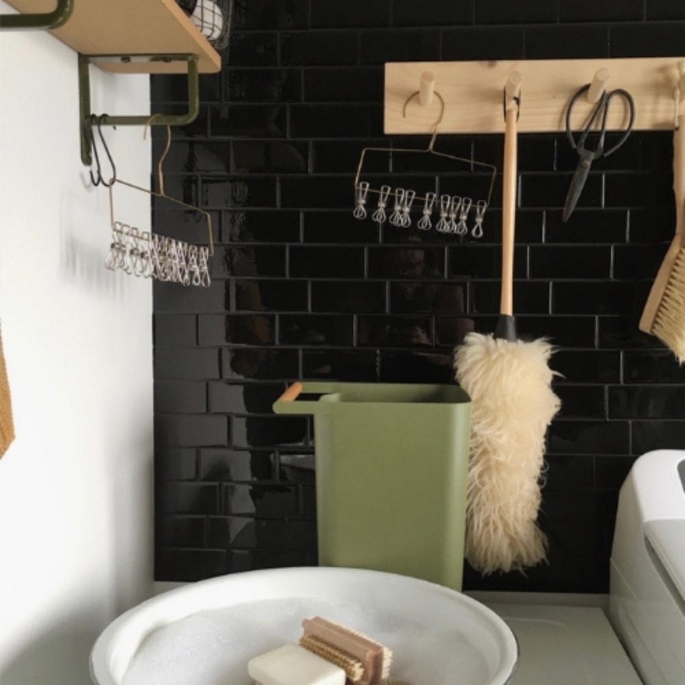 Black self-adhesive 3D subway tile in a laundry room