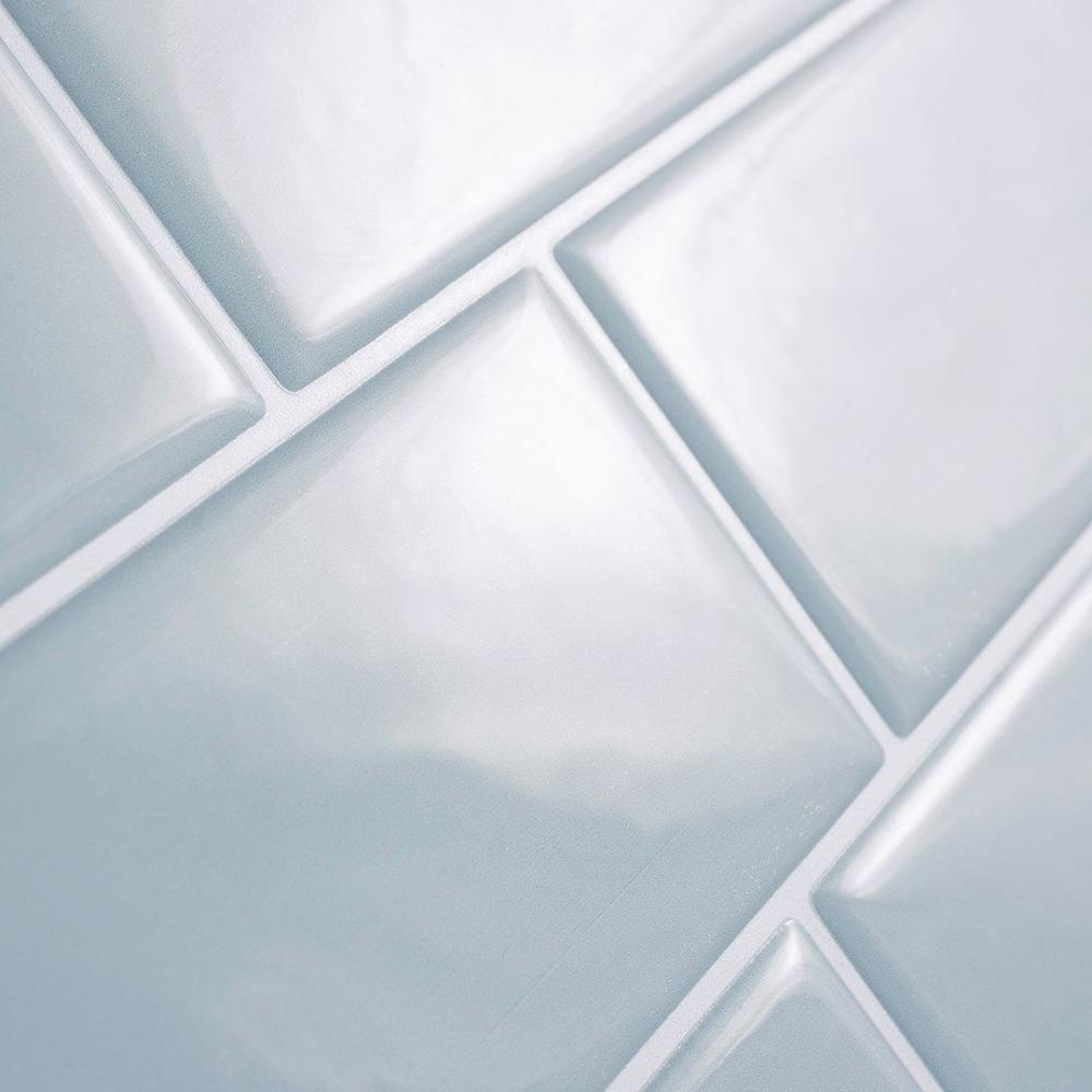 Baby blue subway tiles with white grout that is peel and stick