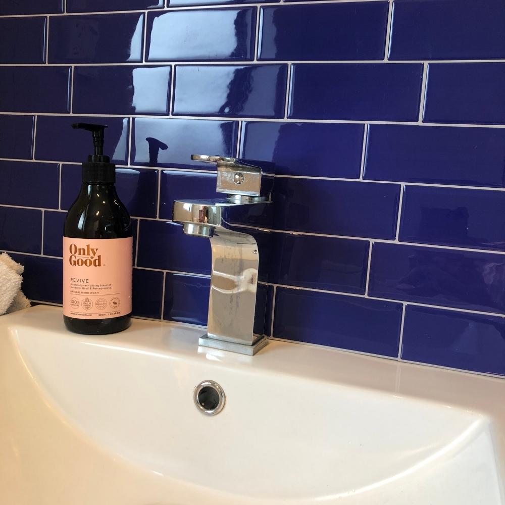Blue self-adhesive 3D subway tile in a bathroom
