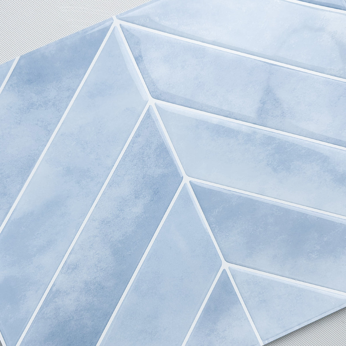Geometric pattern of light blue tiles on a white background