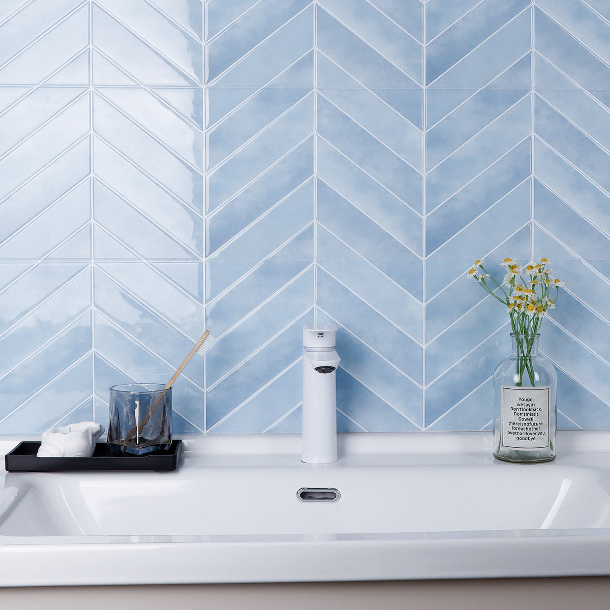 Bathroom sink with blue chevron tiled wall