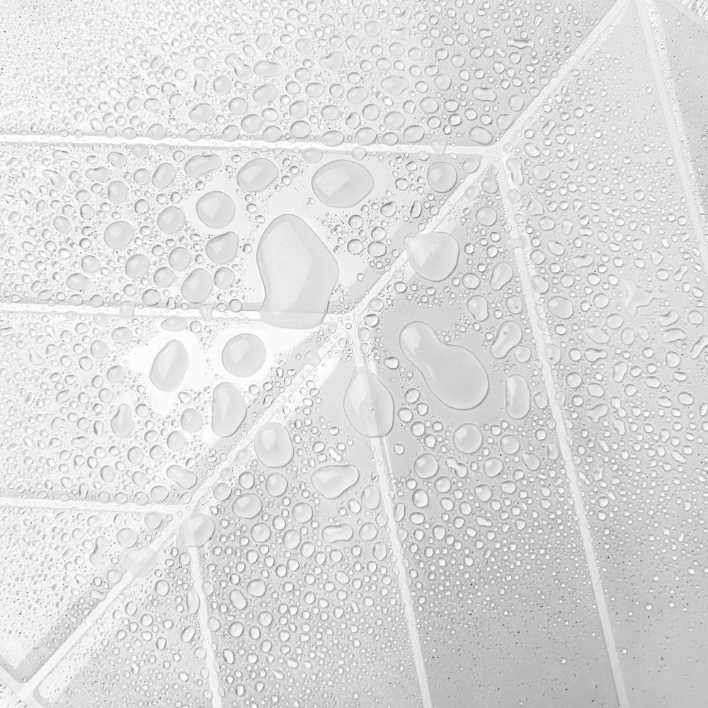 Close-up of water droplets on a chevron tile.
