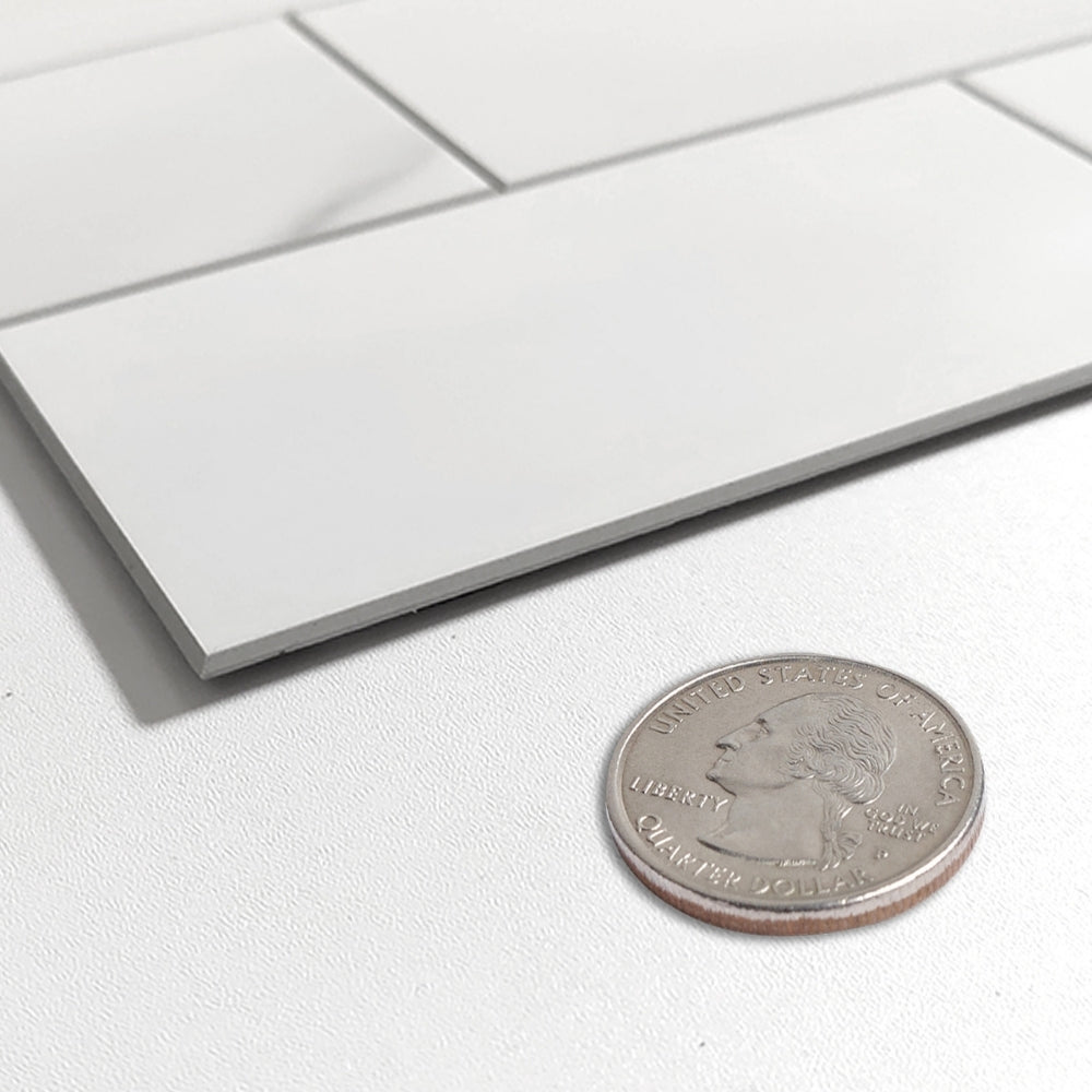 Close-up of a silver coin next to a white marble tile