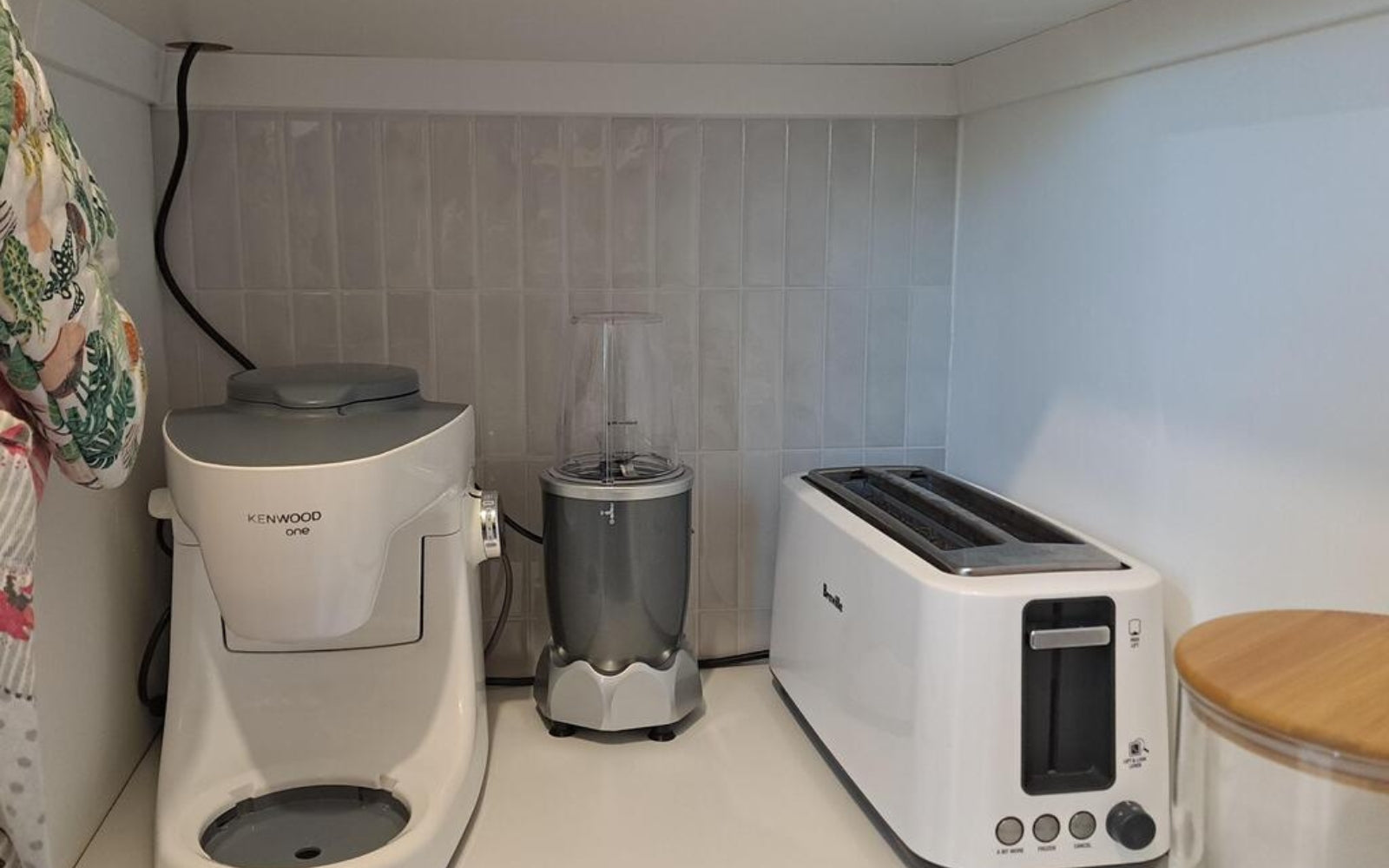 Kitchen appliances including a coffee maker, blender, and toaster on a countertop.