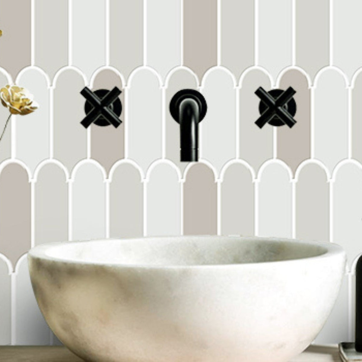 Grey feather wall tiles with white grout above bathroom sink