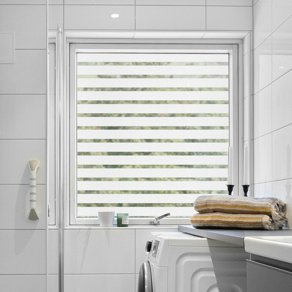 Window with frosted stripes window film in a bathroom setting