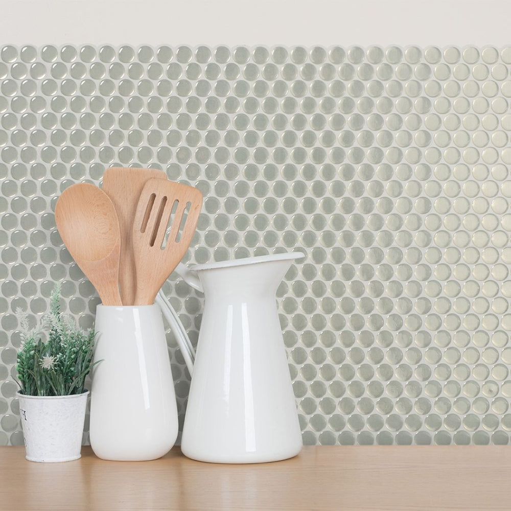 Green penny stick on wall tiles in kitchen