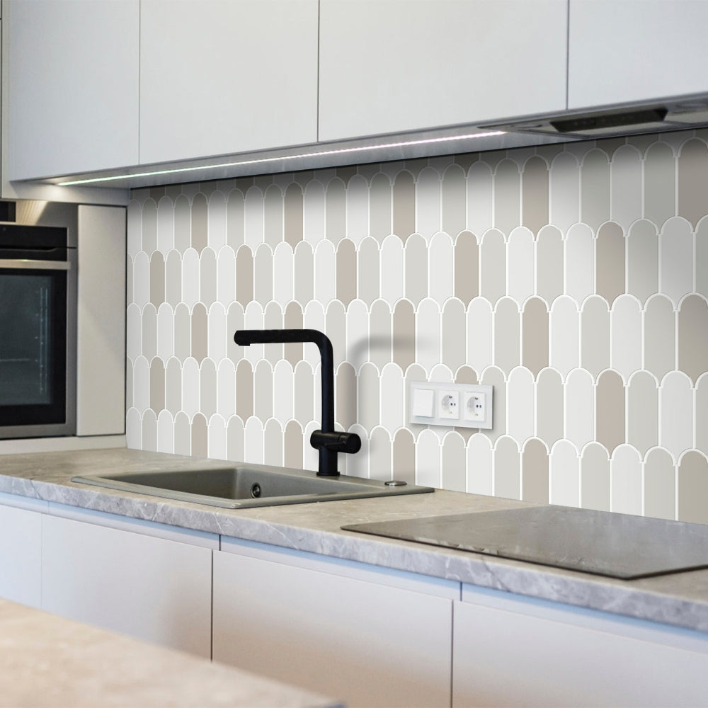 Modern kitchen with geometric patterned backsplash and black faucet.