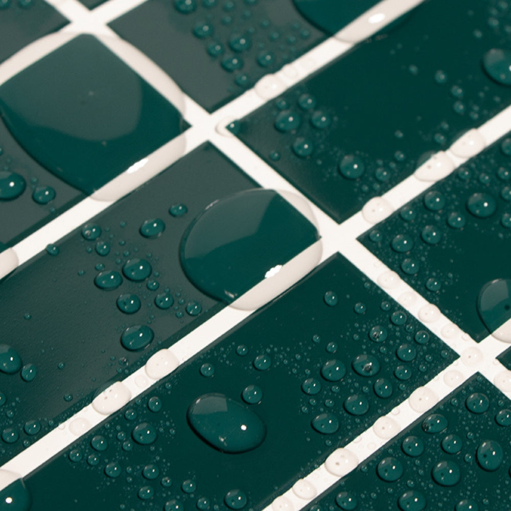 Close-up of green tiles with water droplets on a grid pattern