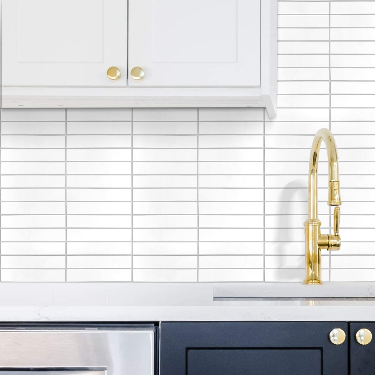 Kitchen with white cabinets, gold faucet, and tiled backsplash.