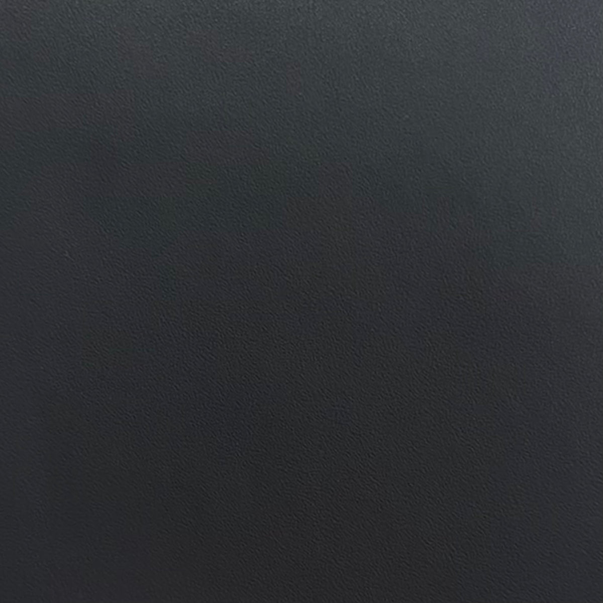 A close-up texture shot of a dark charcoal grey adhesive vinyl, showing a fine grain pattern.