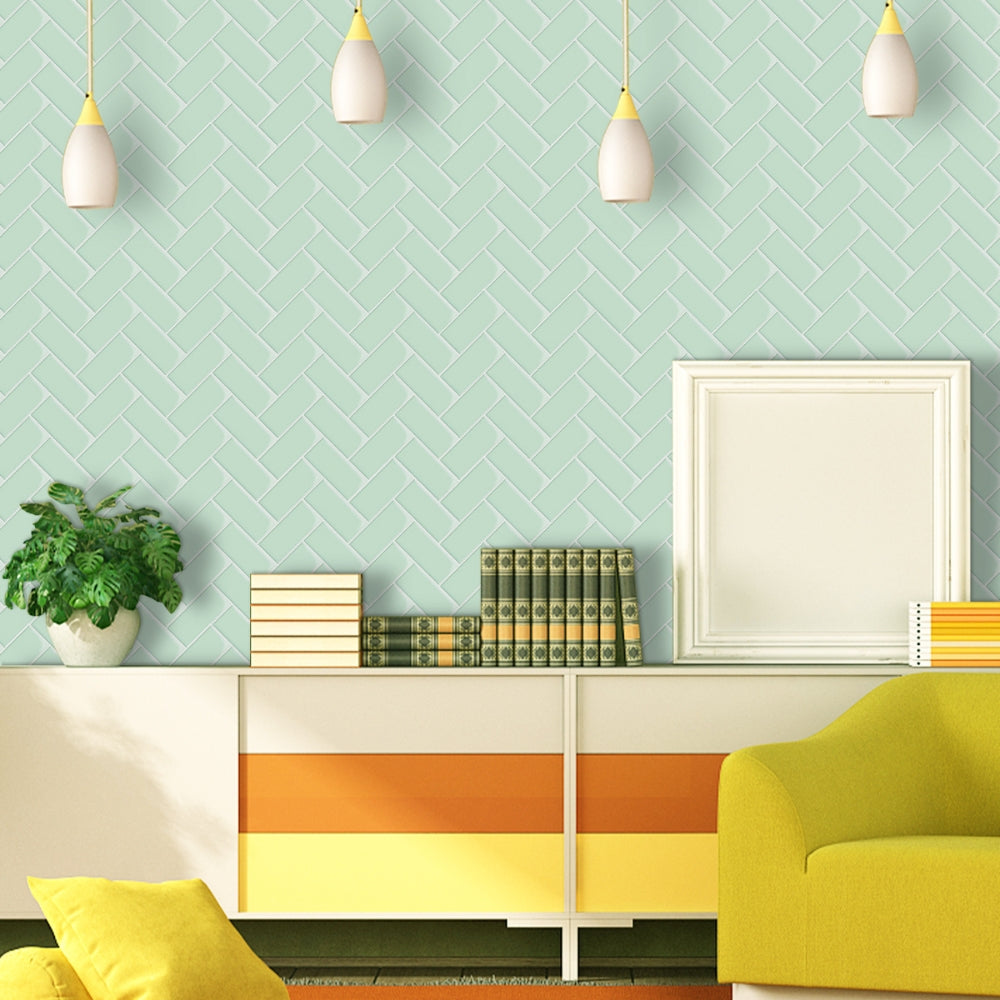 Modern living room with a light green wall, yellow sofa, and decorative elements.