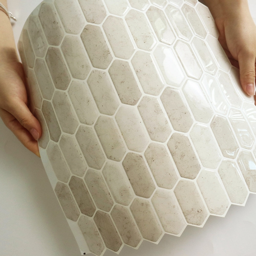 Hexagonal tile with a beige pattern held by hands on a white background