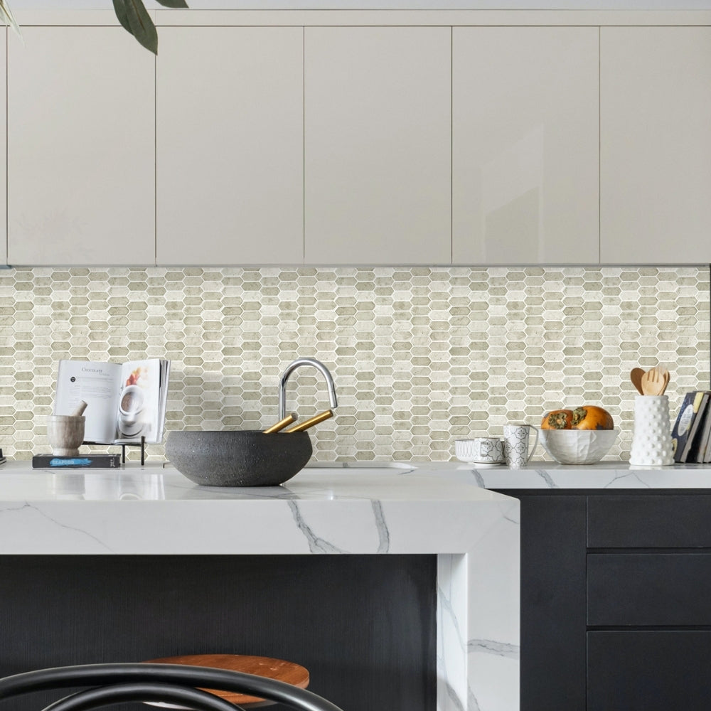 Modern kitchen with white marble countertop, grey cabinets, and a mosaic tile backsplash.