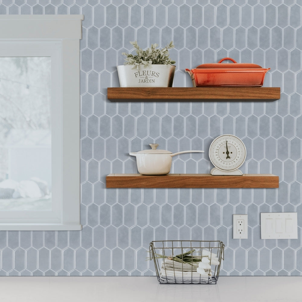 Two wooden shelves with decorative items against a geometric-patterned wall.