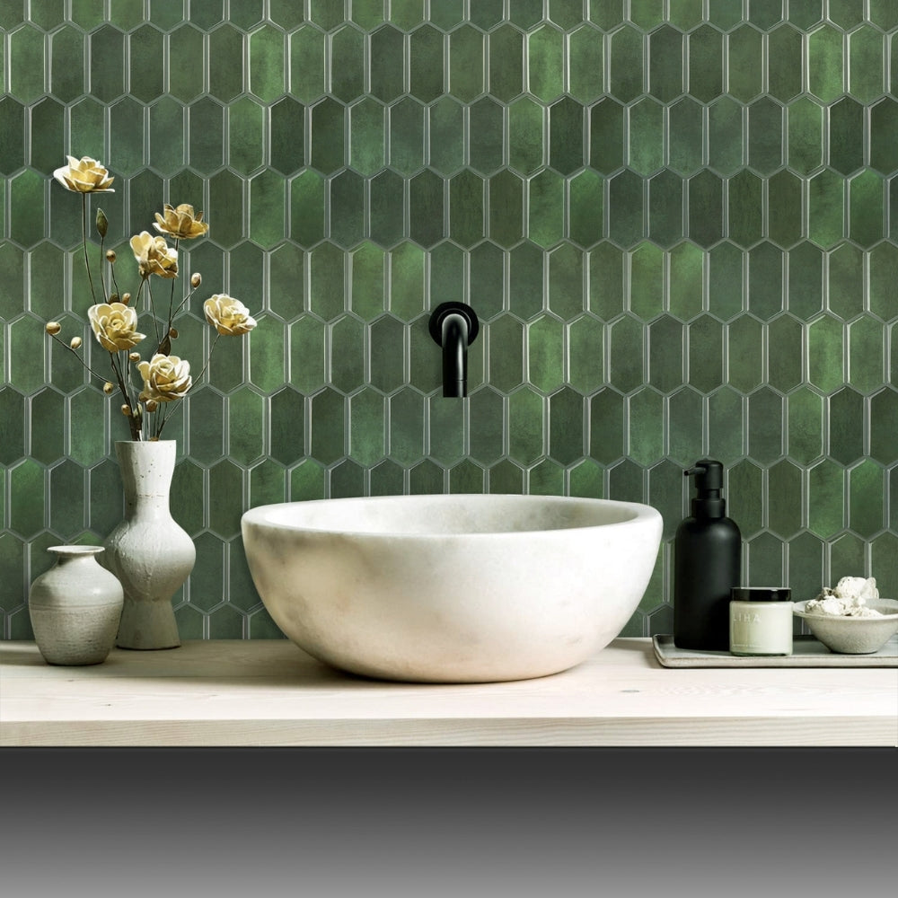 Bathroom setup with a white sink, green tiled wall, and decorative items.
