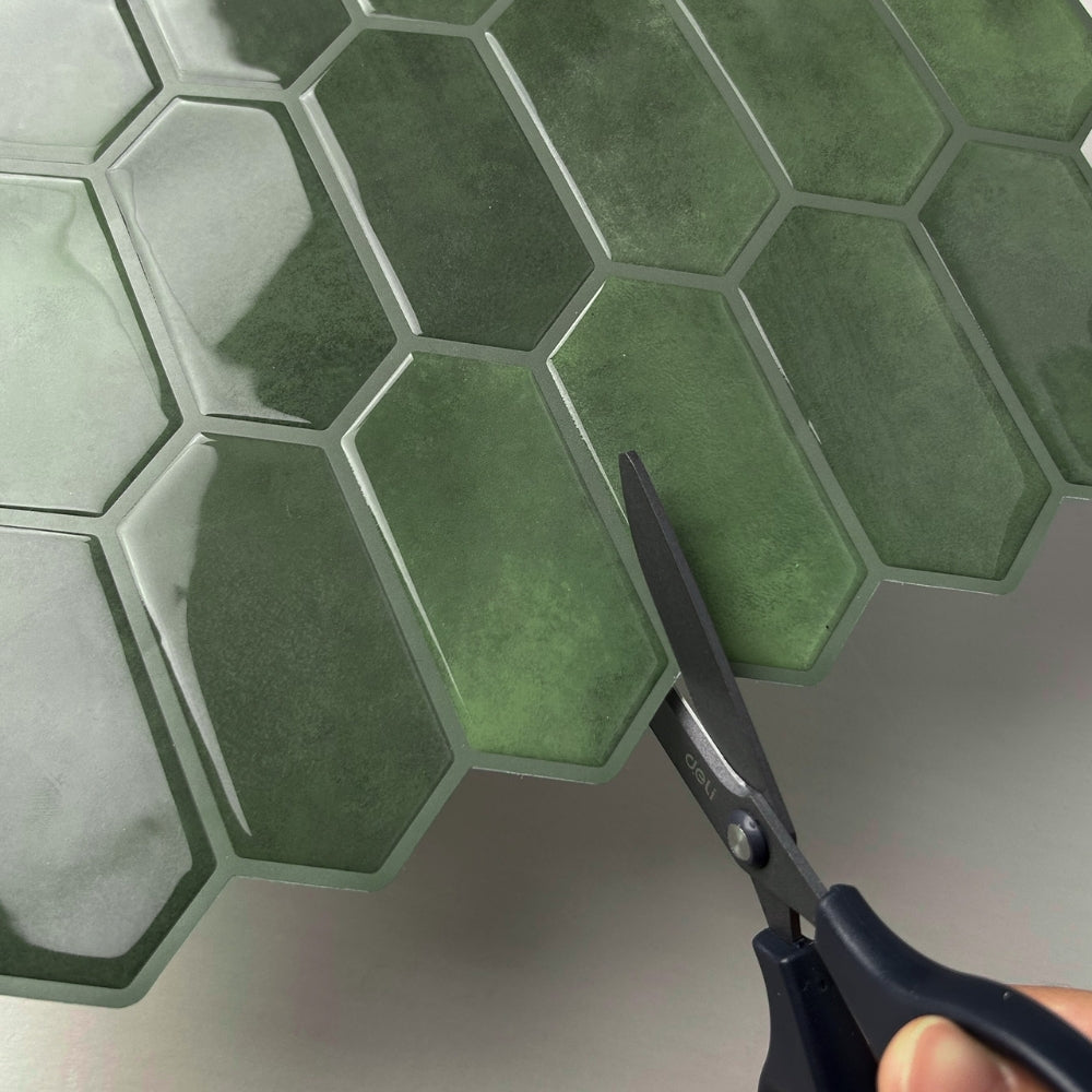 Green hexagonal tiles with a pair of scissors on a white background