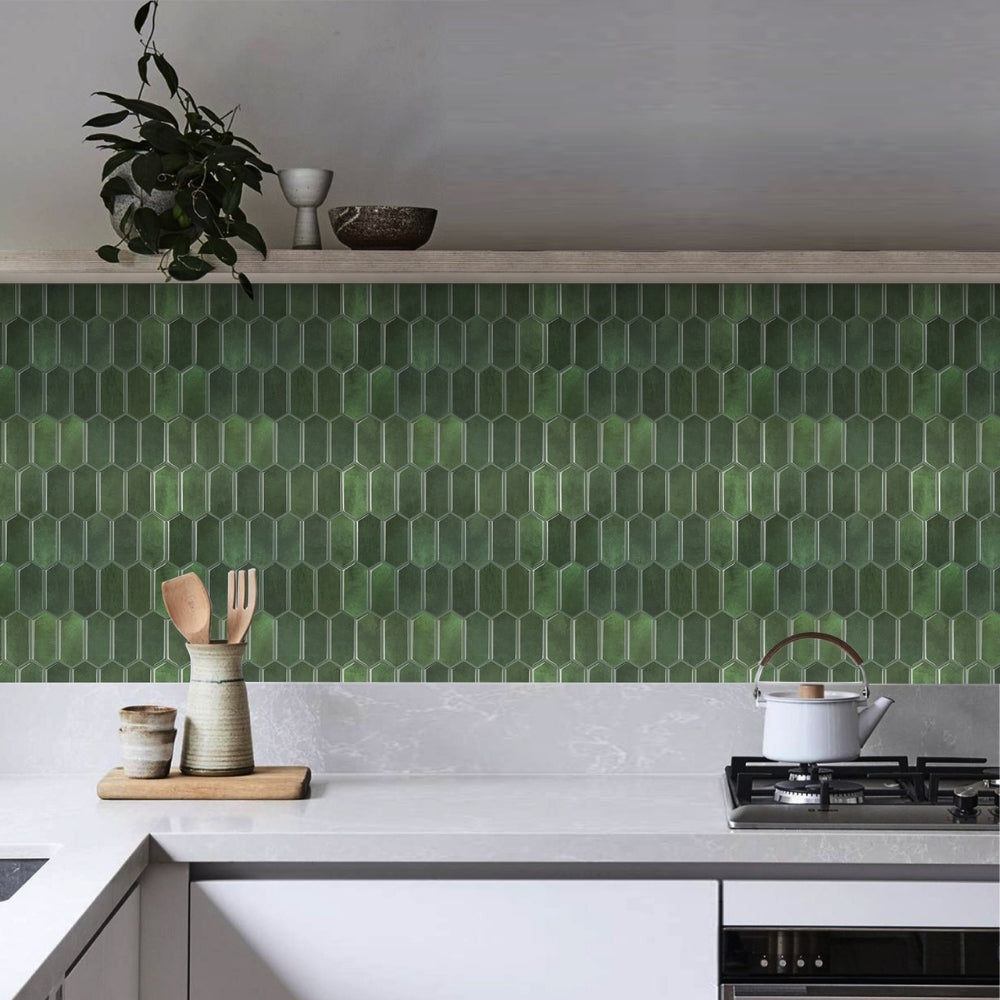 Modern kitchen with green hexagonal tiles on the wall, white countertops, and various kitchen items.