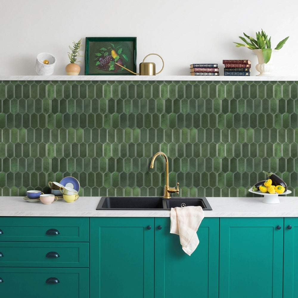 Modern kitchen with green hexagonal tiles, teal cabinets, and white countertop.