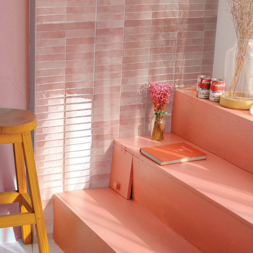 Pink self-adhesive stacked subway tiles on wall