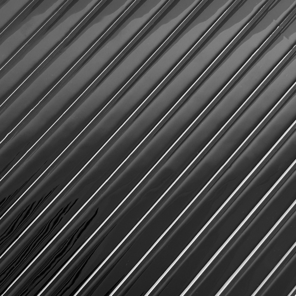 Black reeded tiles that are 3D
