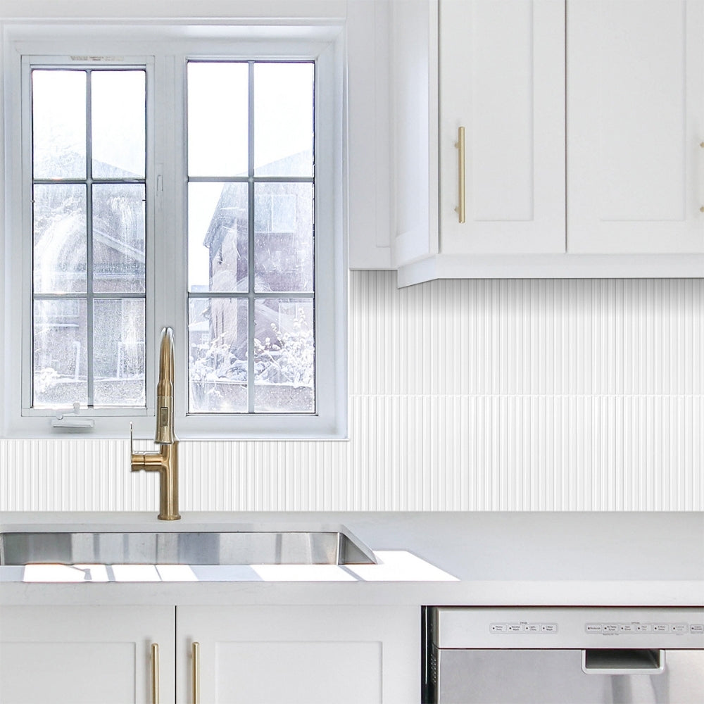 Modern kitchen with white cabinets, a window, and a countertop.