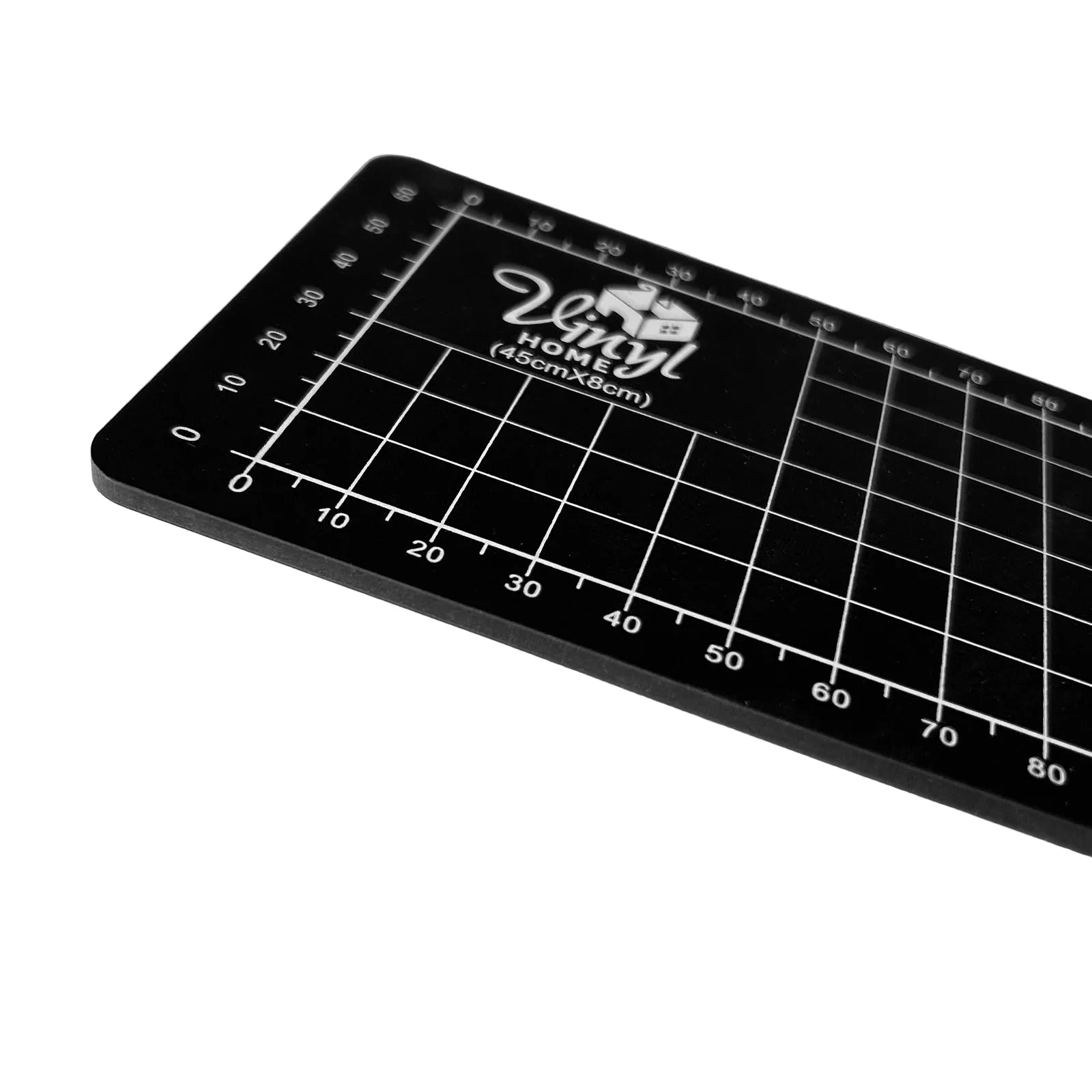 Black cutting mat with grid lines and 'Vinyl Home' branding on a white background