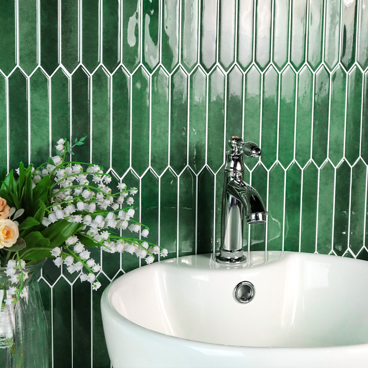 Bathroom sink with green elongated hexagon tiled wall and silver faucet