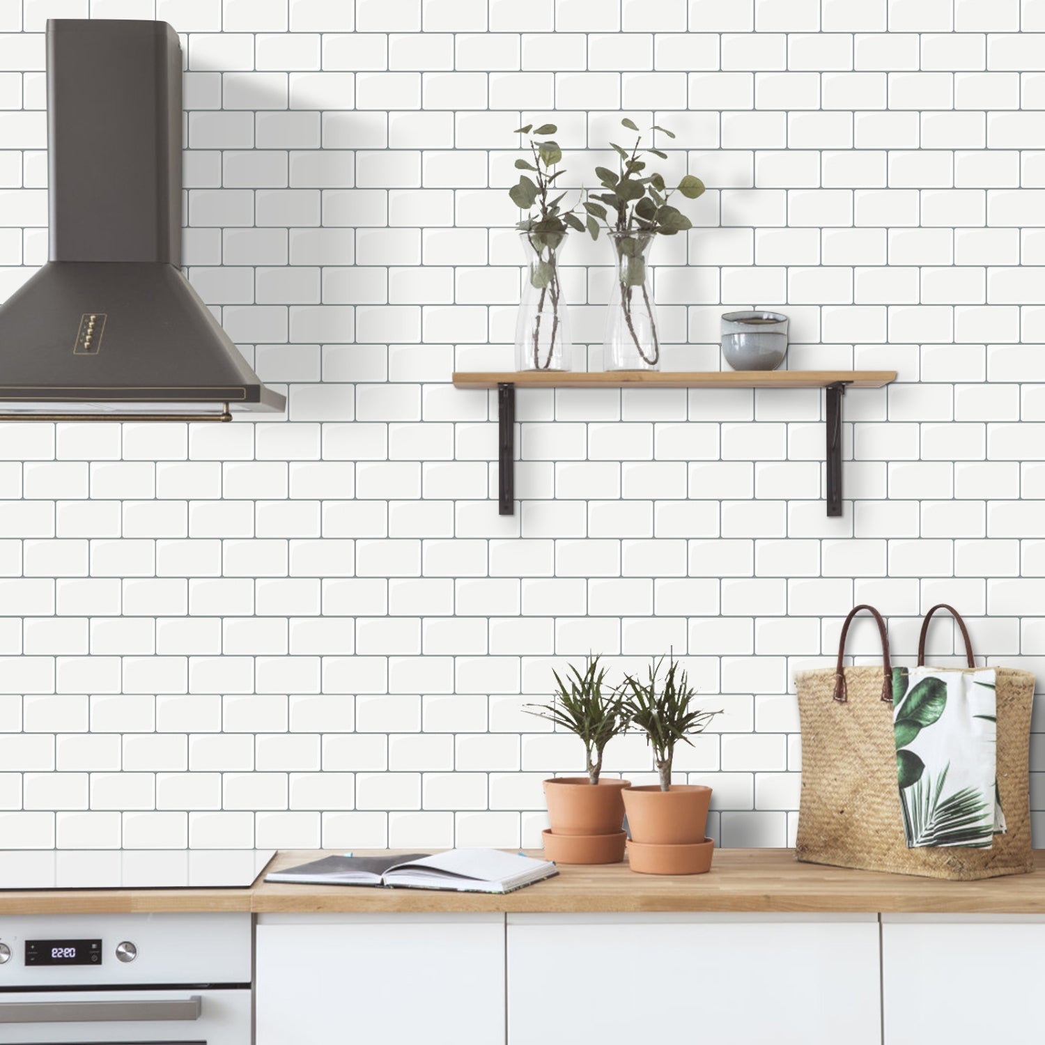 Modern kitchen with white tiled wall, wooden shelf, and plants.