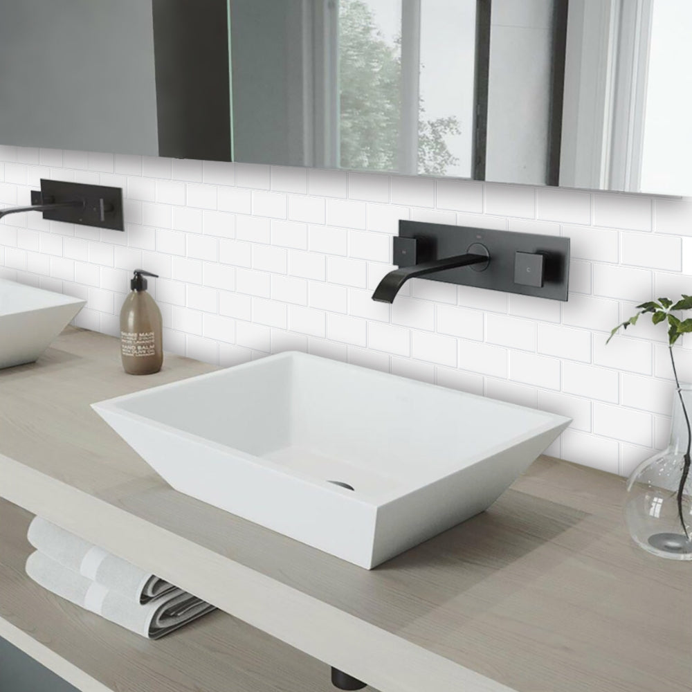 Modern bathroom with a white sink, black faucet, and white tiled wall.