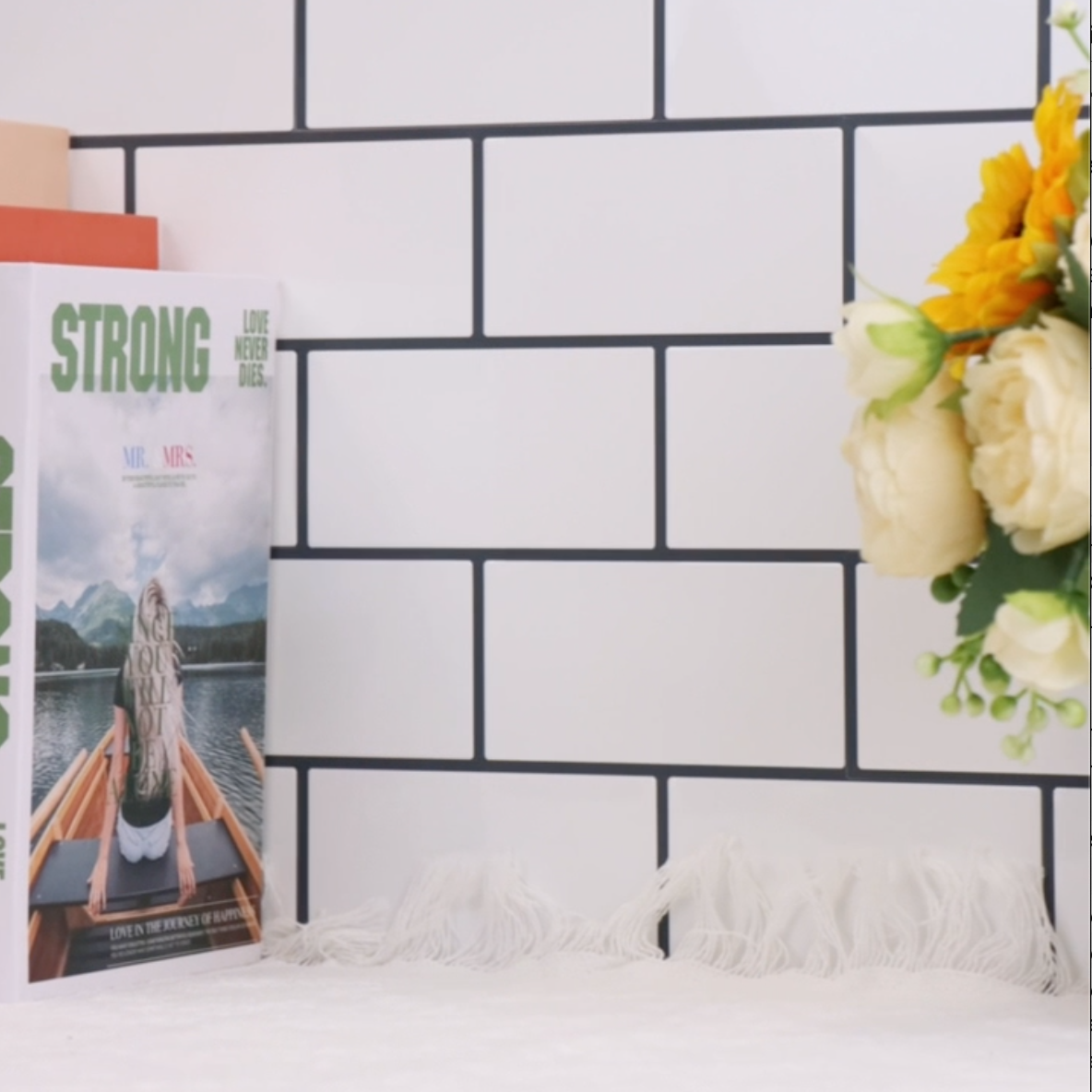 Magazine titled &#39;STRONG&#39; on a white surface with a black grid pattern in the background