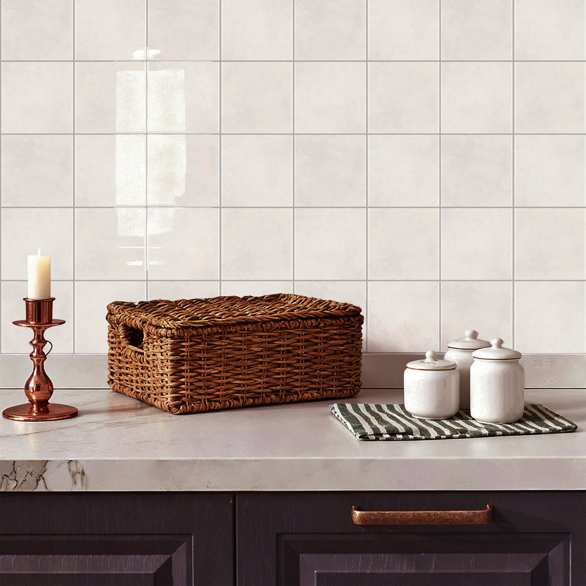 Wicker basket on a kitchen counter with sand coloured tiles in the background