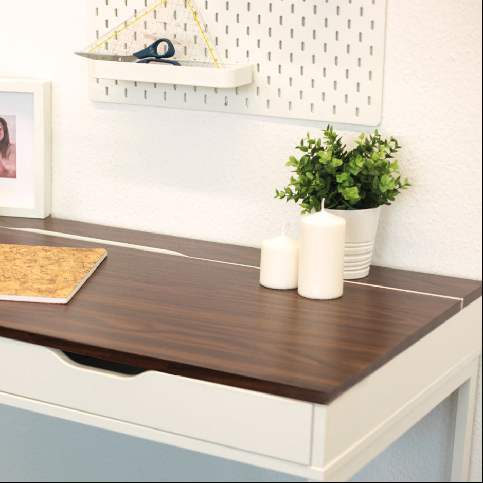 Wooden desk with office supplies and decor in a home office setting